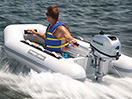A man in a moving boat wearing a life jacket 